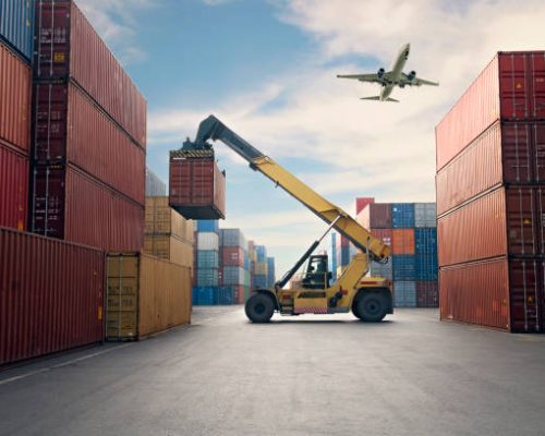 Airplane flying above container port. Airplane flying above container port.